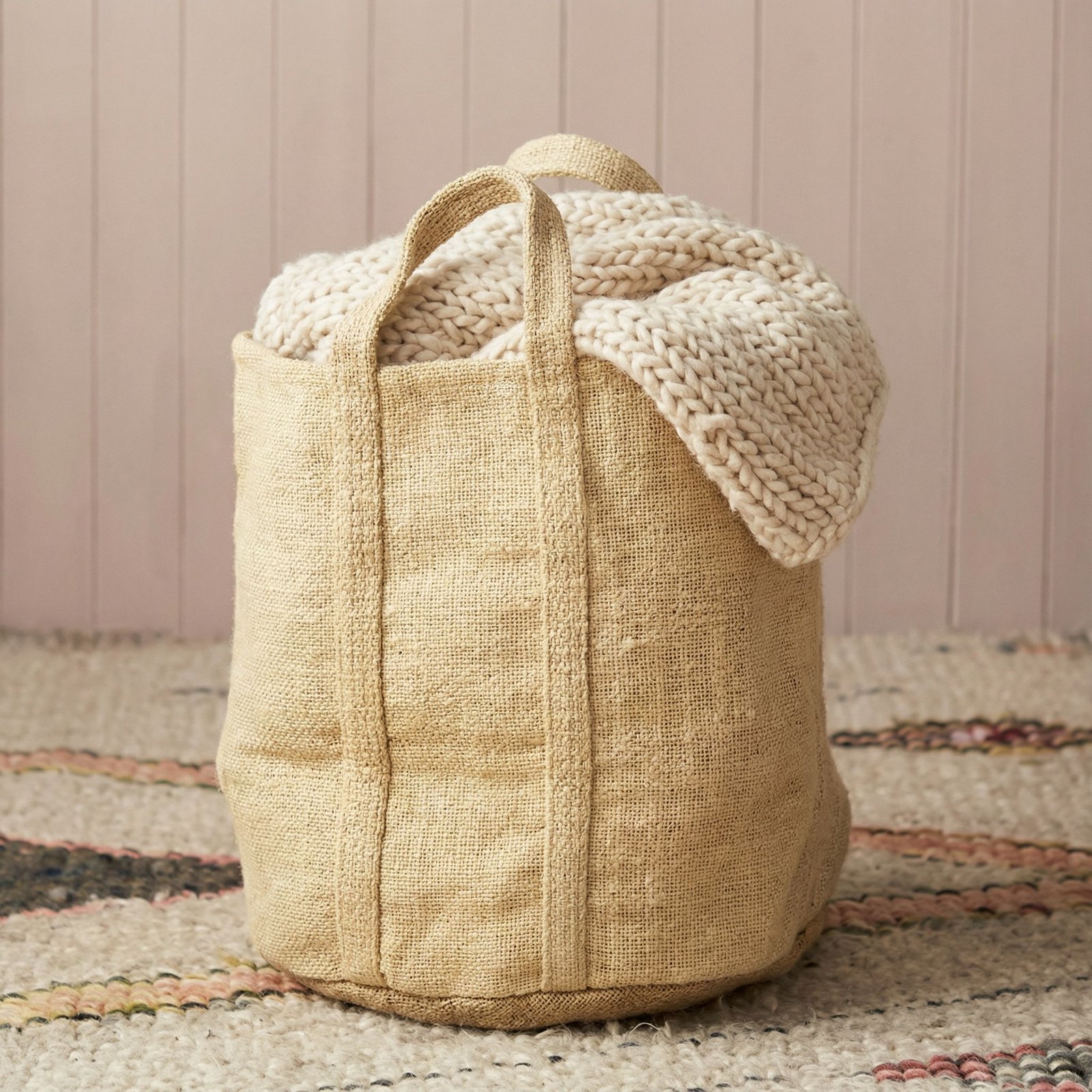 Beige jute storage basket with cream knit blanket